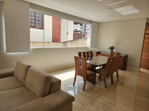 a living room with a couch and a table and chairs at Apto inteiro de luxo em Diamantina in Diamantina