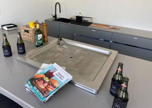 a kitchen counter with a sink and two bottles of beer at Mulwala Resort in Mulwala