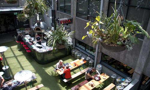 a group of people sitting at tables in a restaurant at West End Precinct 2 Bedroom Apartment close to walkway and ocean in New Plymouth
