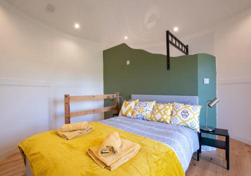 a bedroom with a bed with two towels on it at Caban Silo in Henfynyw Upper