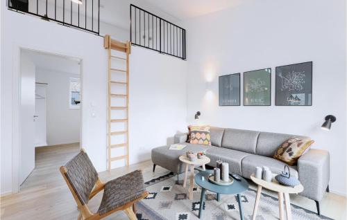 a living room with a couch and a table and chairs at Lovely Home In Lembruchdümmer See in Lembruch
