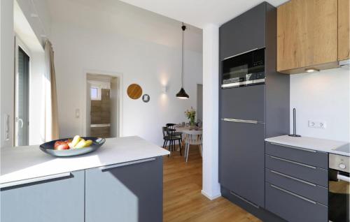 a kitchen with a bowl of fruit on a counter at Lovely Home In Lembruchdümmer See in Lembruch