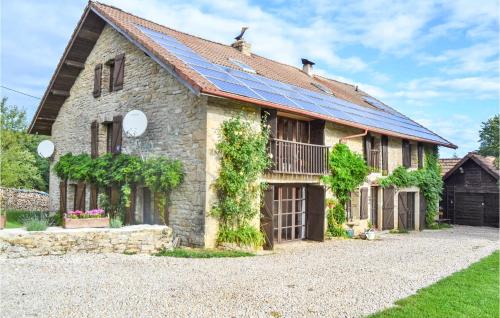 an old stone house with solar panels on it at Beautiful Home In Loisia With Wifi in Loisia