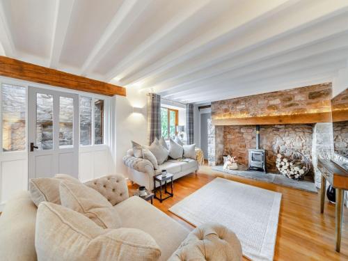 a living room with a couch and a fireplace at Barn On The Wall in Walton