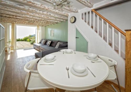 a dining room with a white table and chairs at Glanaber Bach in Abersoch