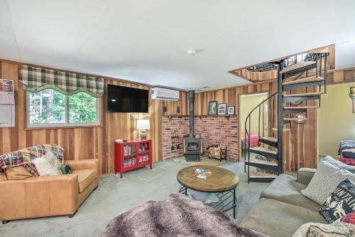 a living room with a loft bed and a staircase at Wandering Elk Cabin Retreat with Golf Access! in Packwood