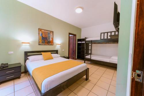 a bedroom with a bed and a desk at Terrazas del Caribe Aparthotel in Puerto Viejo