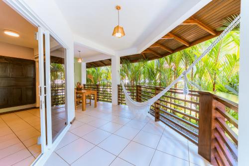 a room with a hammock on a balcony at Terrazas del Caribe Hotel in Puerto Viejo