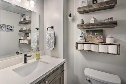 a bathroom with a sink and a toilet and a mirror at Lakefront Family Retreat Skiing and Mountain Biking in Greenwood