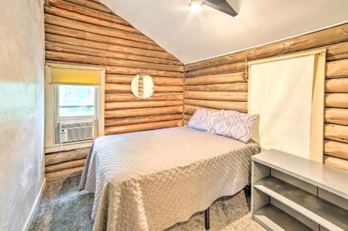 a bedroom with a bed in a room with wooden walls at Crivitz Lakefront Escape with Boat Dock and Slip! in Crivitz