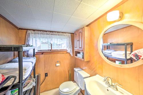 a small room with a toilet and a sink and a mirror at Crivitz Lakefront Escape with Boat Dock and Slip! in Crivitz