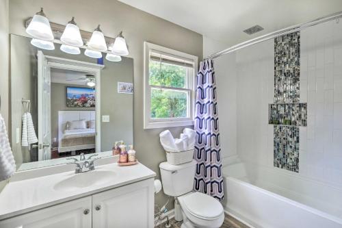 a bathroom with a toilet and a tub and a sink at Louisville Apartment - Walk to Restaurants! in Louisville