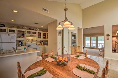a kitchen and dining room with a large wooden table at Fire Pit and Boat Dock Lake Chatuge Townhome! in Hiawassee