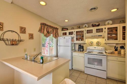 a kitchen with a white refrigerator and a sink at Fire Pit and Boat Dock Lake Chatuge Townhome! in Hiawassee
