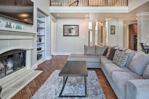 a living room with a couch and a fireplace at Spacious Home with Backyard about 25 Mi to Houston! in Manvel