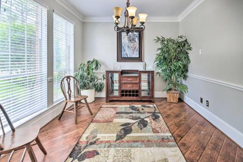 a living room with a table and chairs and a rug at Spacious Home with Backyard about 25 Mi to Houston! in Manvel