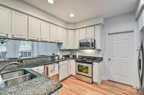 a kitchen with white cabinets and a stove top oven at Gorgeous Pinehurst No 6 Home with Two Patios! in Pinehurst