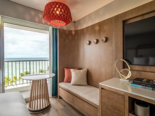 a room with a couch and a table and a window at Crowne Plaza Resort Guam in Tumon