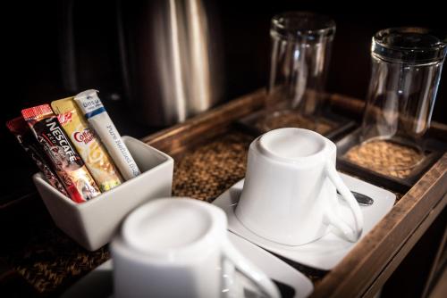 a table with a tray with a coffee cup and a tray of food at Am Samui Palace in Lamai