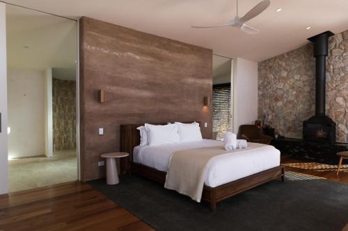 a bedroom with a large bed and a fireplace at Chalets at Blackheath in Blackheath