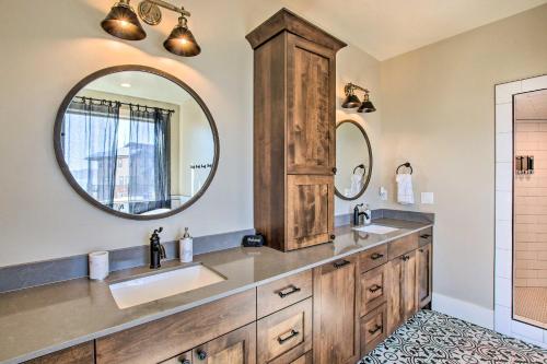 a bathroom with two sinks and a large mirror at Fish Haven Hideaway with Private Lake Access! in Fish Haven