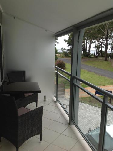 a room with a balcony with a view of a street at Jervis Bay Mariners in Huskisson