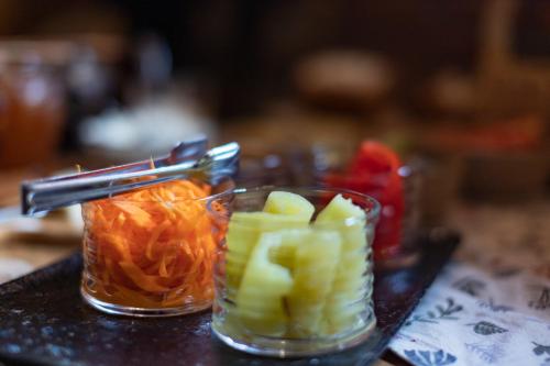 two glass cups filled with fruit on a table at Menabde Winery in Ozurgetʼi