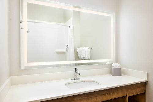 a white bathroom with a sink and a mirror at Holiday Inn Express & Suites Bridgeport by IHG in Bridgeport