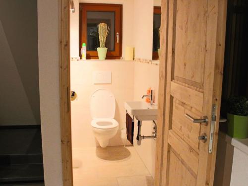 a bathroom with a toilet and a sink at Feriendorf X-Alp Lodges Ötztal in Sautens
