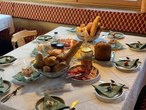 a table with plates of food on it at Pension Dorferwirt in Bramberg am Wildkogel