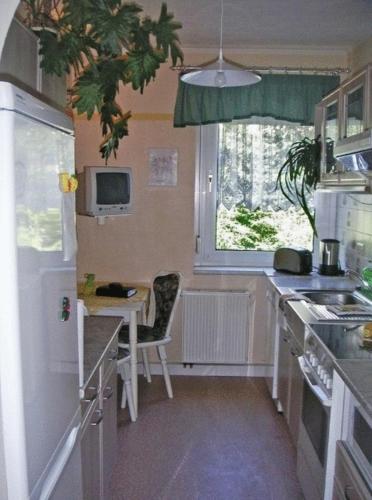 a small kitchen with a table and a desk at Zeche 33 in Kurort Oberwiesenthal