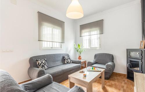 a living room with two couches and a table at 3 Bedroom Gorgeous Home In Malaga in Málaga