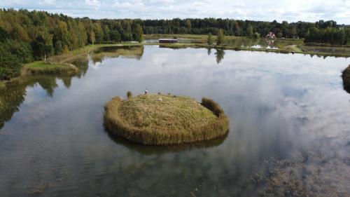 a small island in the middle of a lake at Putraimi. in Princmuiza