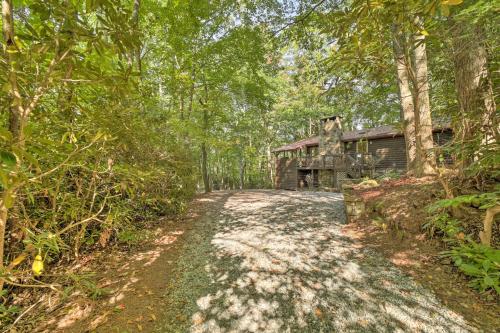 a dirt road leading to a house in the woods at Fire Pit and Grill Cozy Cabin in Lake Toxaway! in Lake Toxaway