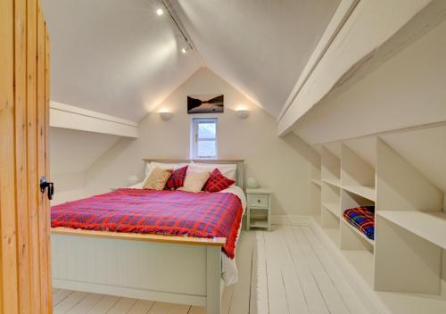 a bedroom with a bed in a attic at Ty Rowan in Trefriw