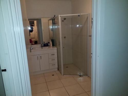 a bathroom with a shower and a sink at The DOLPHIN PLACE in Australind