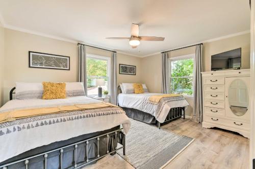 a bedroom with two beds and a dresser with a mirror at Lakefront Sherrills Ford Haven with Boat Dock! in Denver