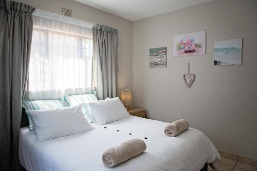 a bedroom with two stuffed animals on a bed at Uitspan in St Lucia