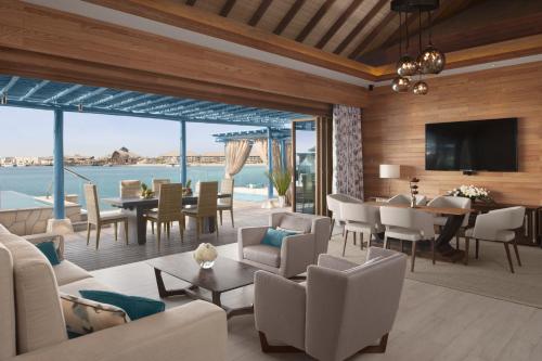 a living room with a view of the ocean at Banana Island Resort Doha by Anantara in Doha