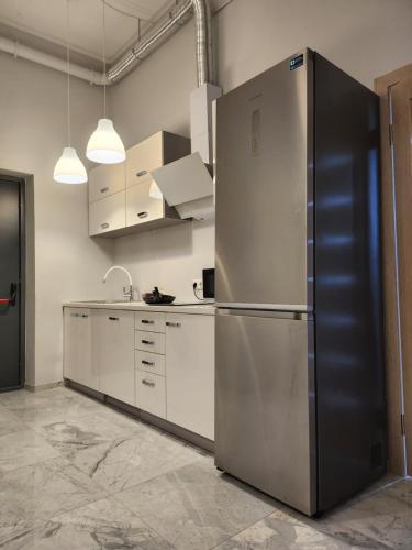 a kitchen with a large stainless steel refrigerator at Hostel Riga KVANT in Riga