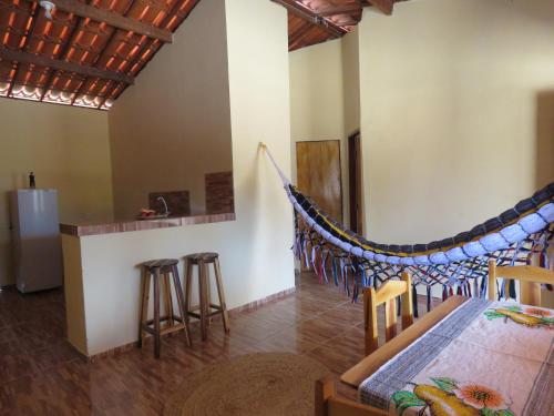 a bedroom with a hammock in a room at Alameda dos Coqueirais in Icaraí