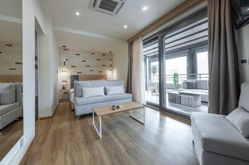 a living room with a couch and a table at Hotel @Syngrou Fix in Athens