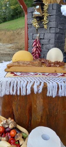 a table with a bunch of food on it at Pensiunea Valea Branzei in Năneşti