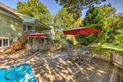 a patio with a table and umbrella and a pool at Amish Country Apartment with Cozy Fireplace! in New Holland