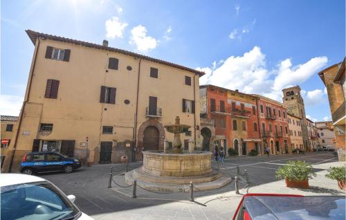 a fountain in the middle of a street with buildings at 2 Bedroom Beautiful Apartment In Deruta in Deruta
