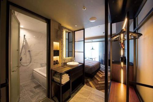 a bathroom with a sink and a tub and a shower at SHIBUYA STREAM HOTEL formerly Shibuya Stream Excel Hotel Tokyu in Tokyo