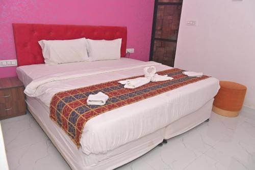 a bed with two towels and a stuffed animal on it at Hotel Apni Haveli in Udaipur
