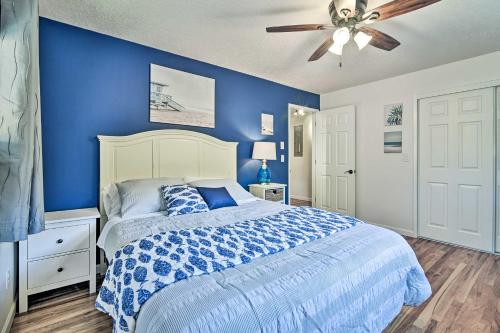 a blue bedroom with a bed and a ceiling fan at Charming Hillsboro Home with Yard, Dogs Welcome in Hillsboro