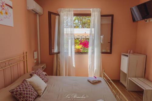 a bedroom with a large bed and a window at La Pomelia B&b Sofia in Trappitello