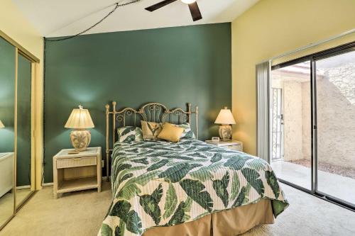 a bedroom with a bed and a green wall at Cathedral City Golf Course Condo with Patio in Cathedral City